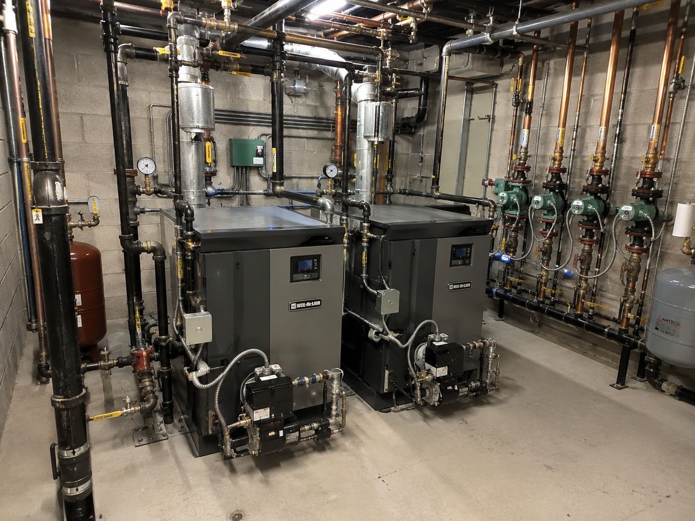 A building mechanical room with boilers and piping.
